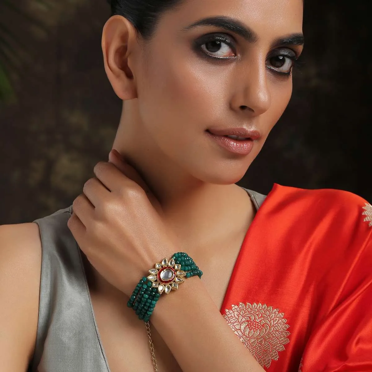 Gold Plated Kundan Bracelet With Emerald Green Stones Bead Strings And Mina Kari Detailing On The Edges By Paisley Pop